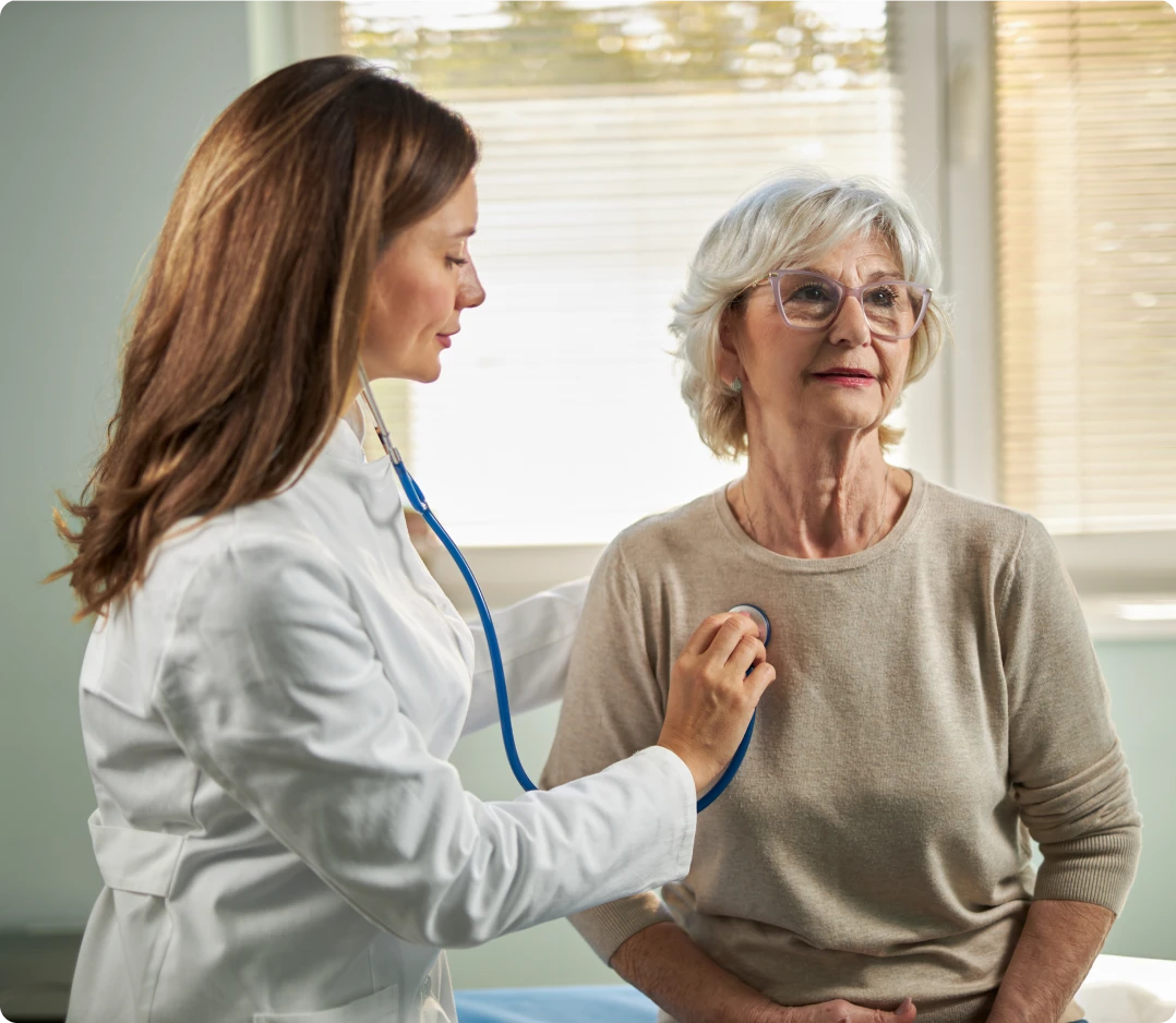Physician checking senior patient's heart