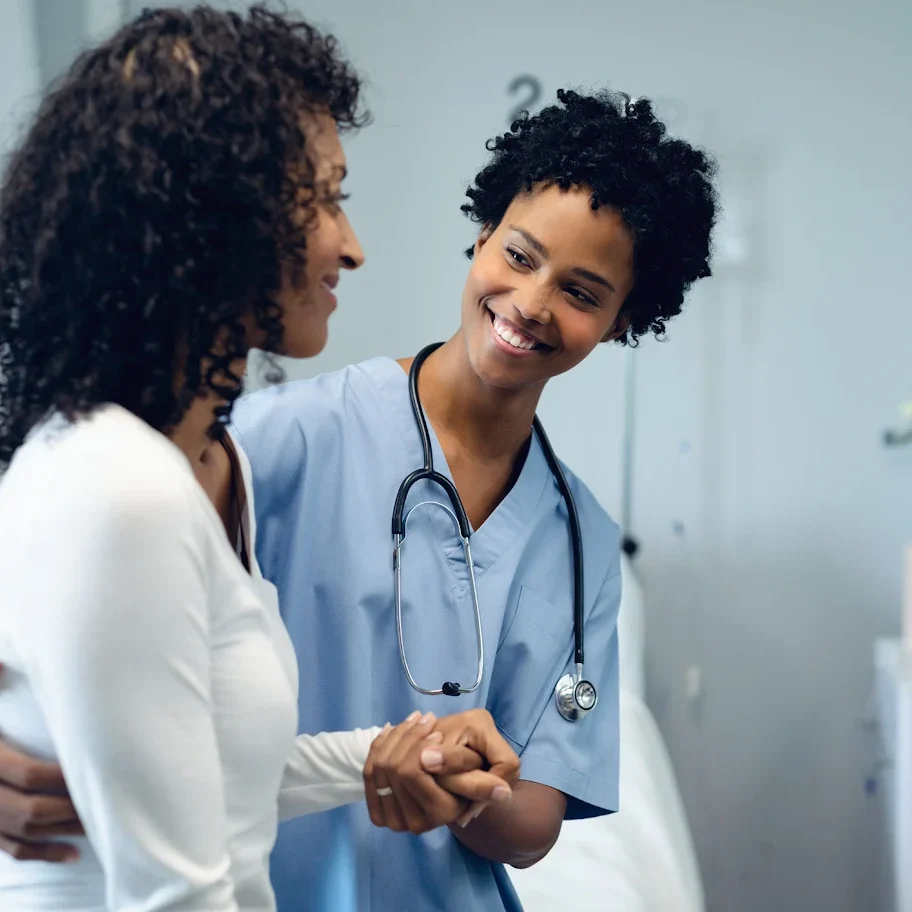 Doctor warmly consulting with a patient in a medical office.